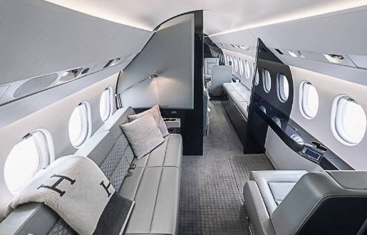 Fig-air_9-falcon-900-ex_p4.2 Interior photo showing the length of the cabin of FIG Air’s Falcon 900 EX jet. Luxurious grey jet interior seating, carpet and decor.