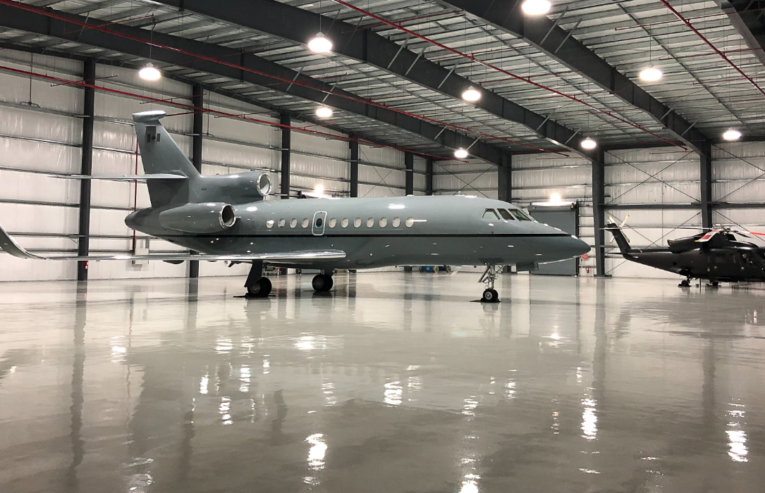 Photo of FIG Air’s Falcon 900 EX jet in a hangar