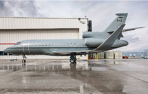 fig-air_9-falcon-900-ex_p5.2 Side view photo of FIG Air’s Falcon 900 EX jet on the ground, outside, at an airport.