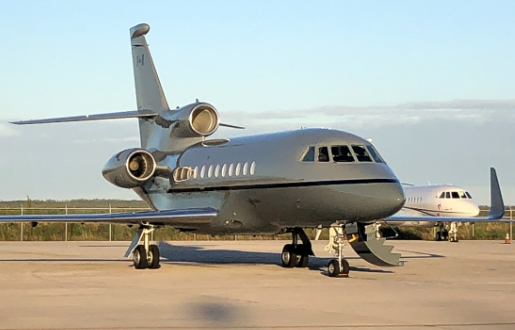 fig-air_9-falcon-900-ex_p6.2 Photo of FIG Air’s Falcon 900 EX jet on the ground, outside, at an airport with the steps released.